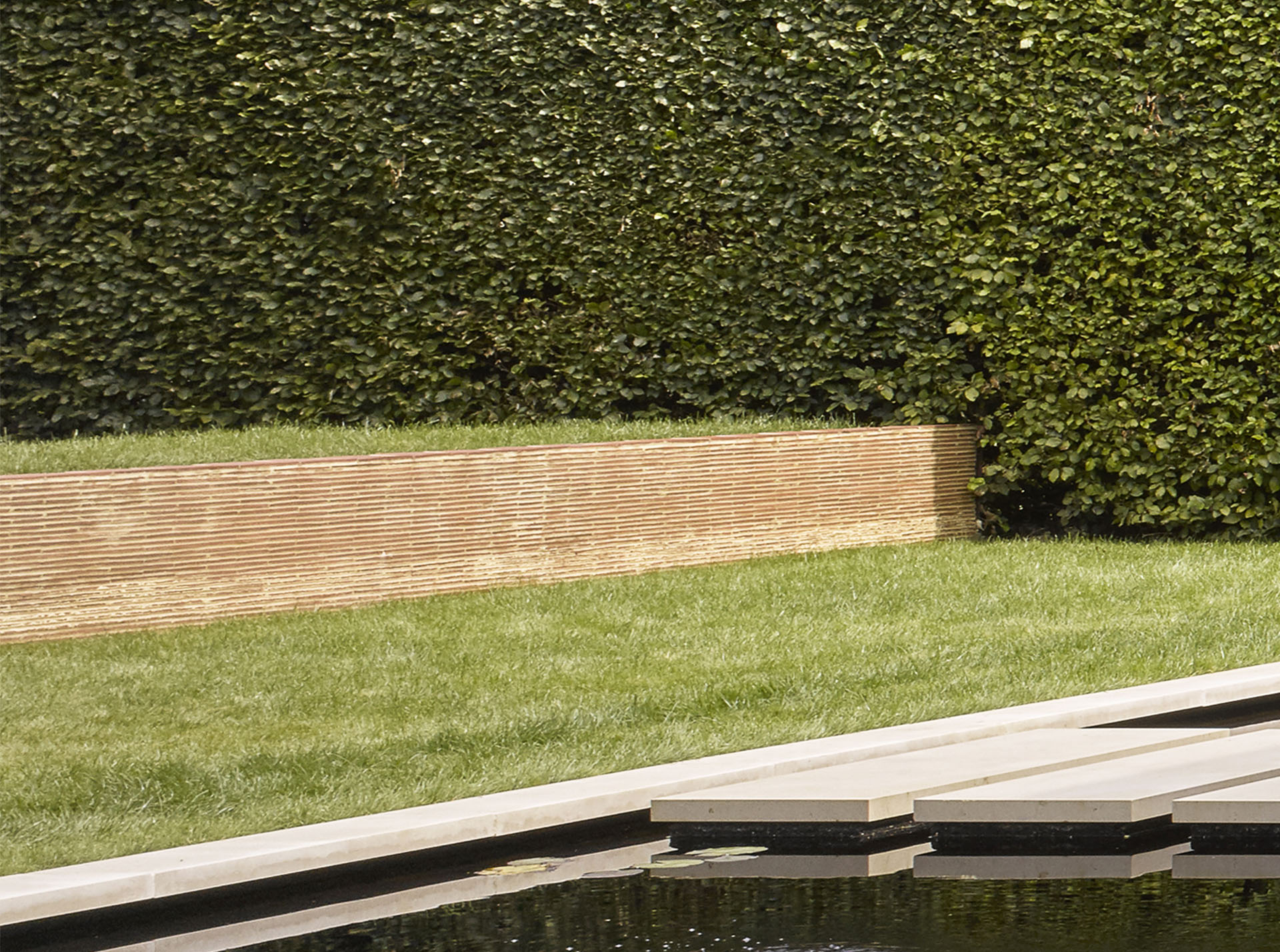 stacked clay creasing tiles create detail in a garden wall